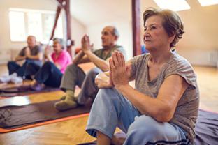 Group of older people meditating