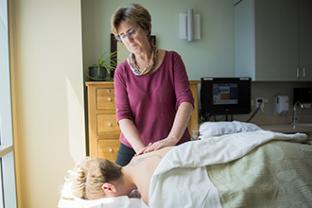 Massage therapist working with patient