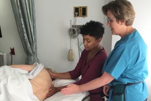 Carolyn Tague trains a student in inpatient massage 