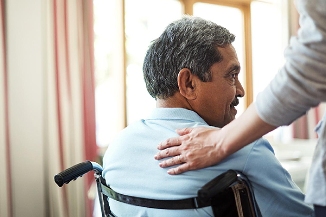 Man sitting in wheelchair smiling