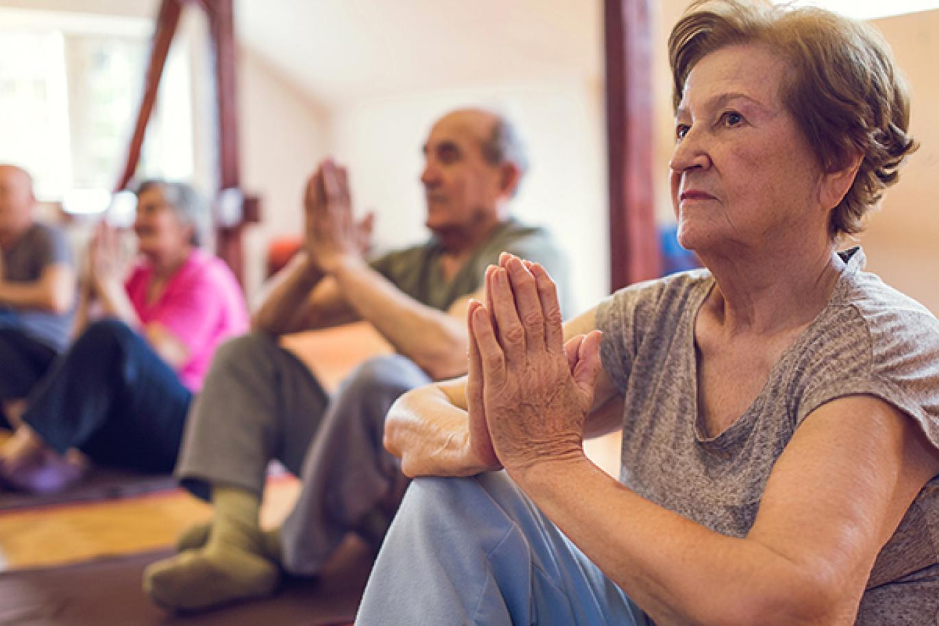 Group of older people meditating