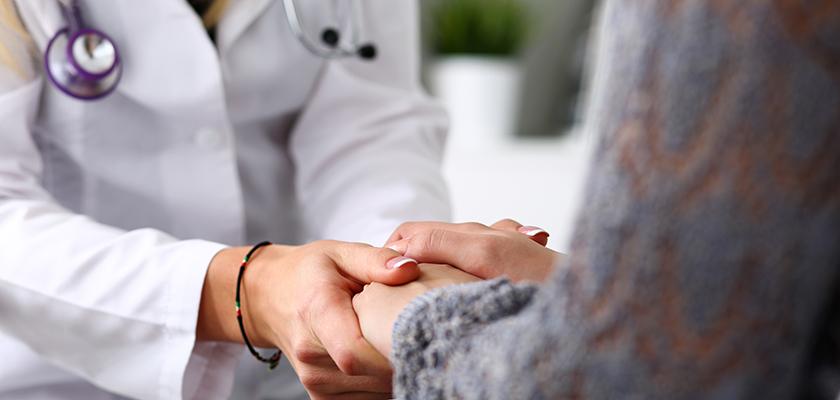 Doctor holding patients hand