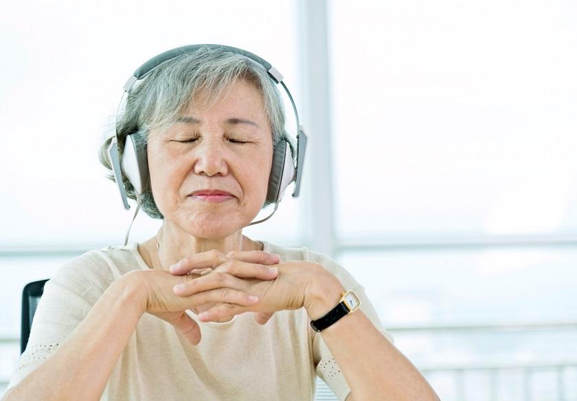 Person listening to guided meditation with headphones