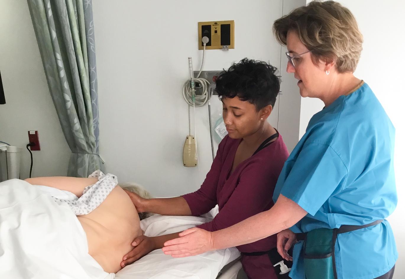 Carolyn Tague instructs a massage therapist