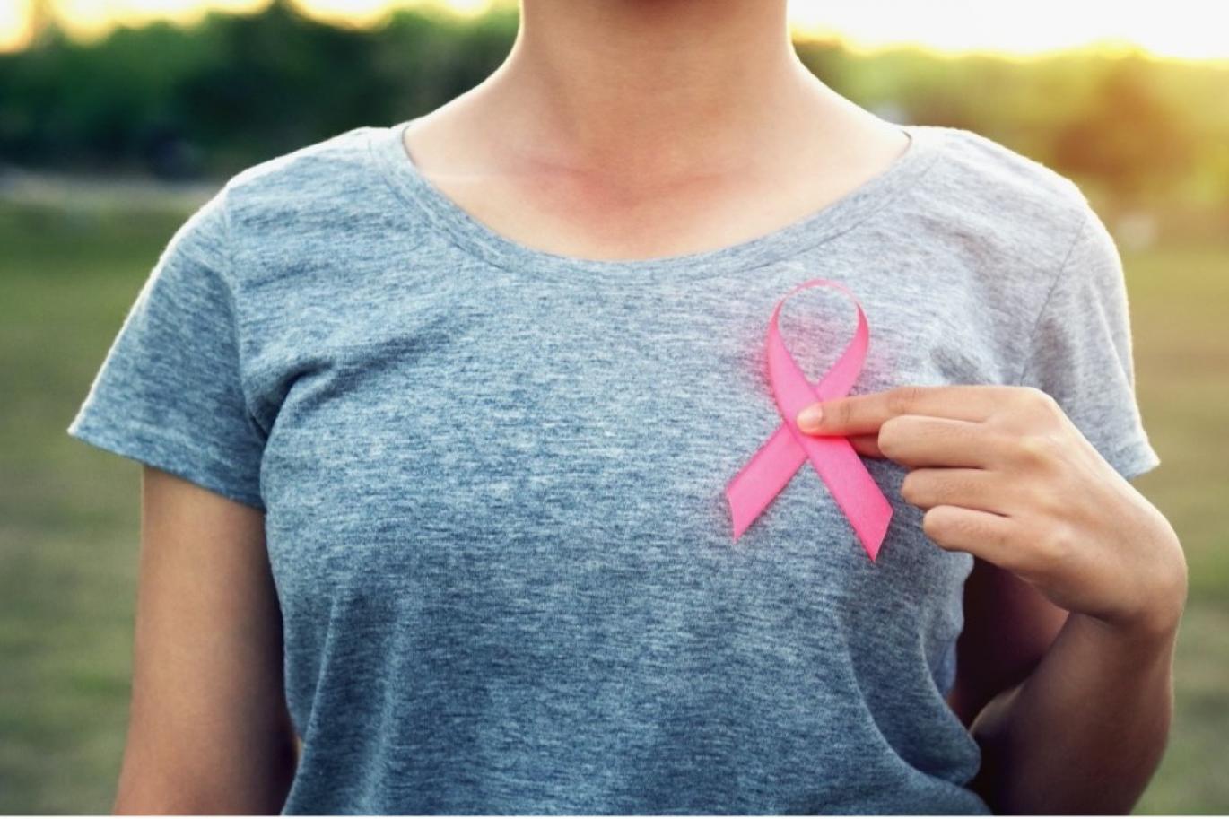 Woman holding a pink ribbon