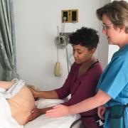 Carolyn Tague trains a student in inpatient massage 